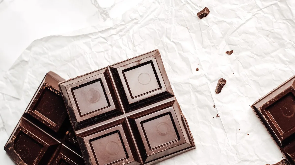 Squares of dark chocolate on crumpled white paper